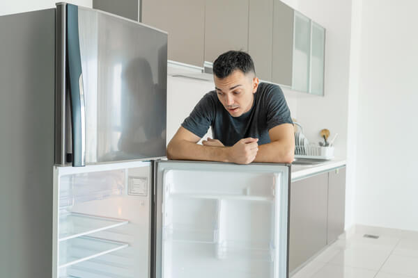 A man with an empty fridge