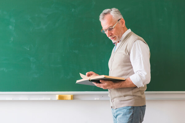 A teacher reading the textbook