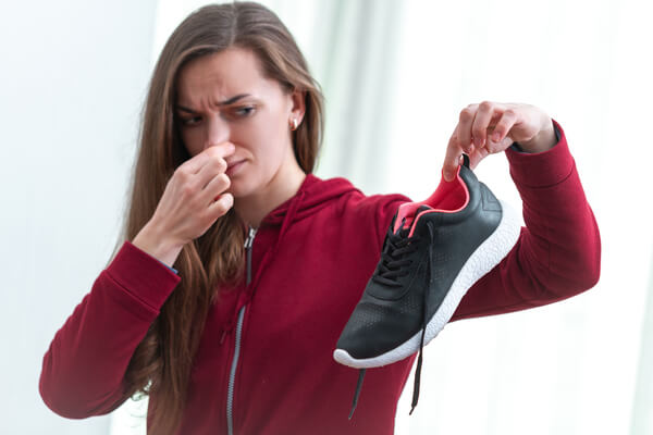 A woman smelling a shoe